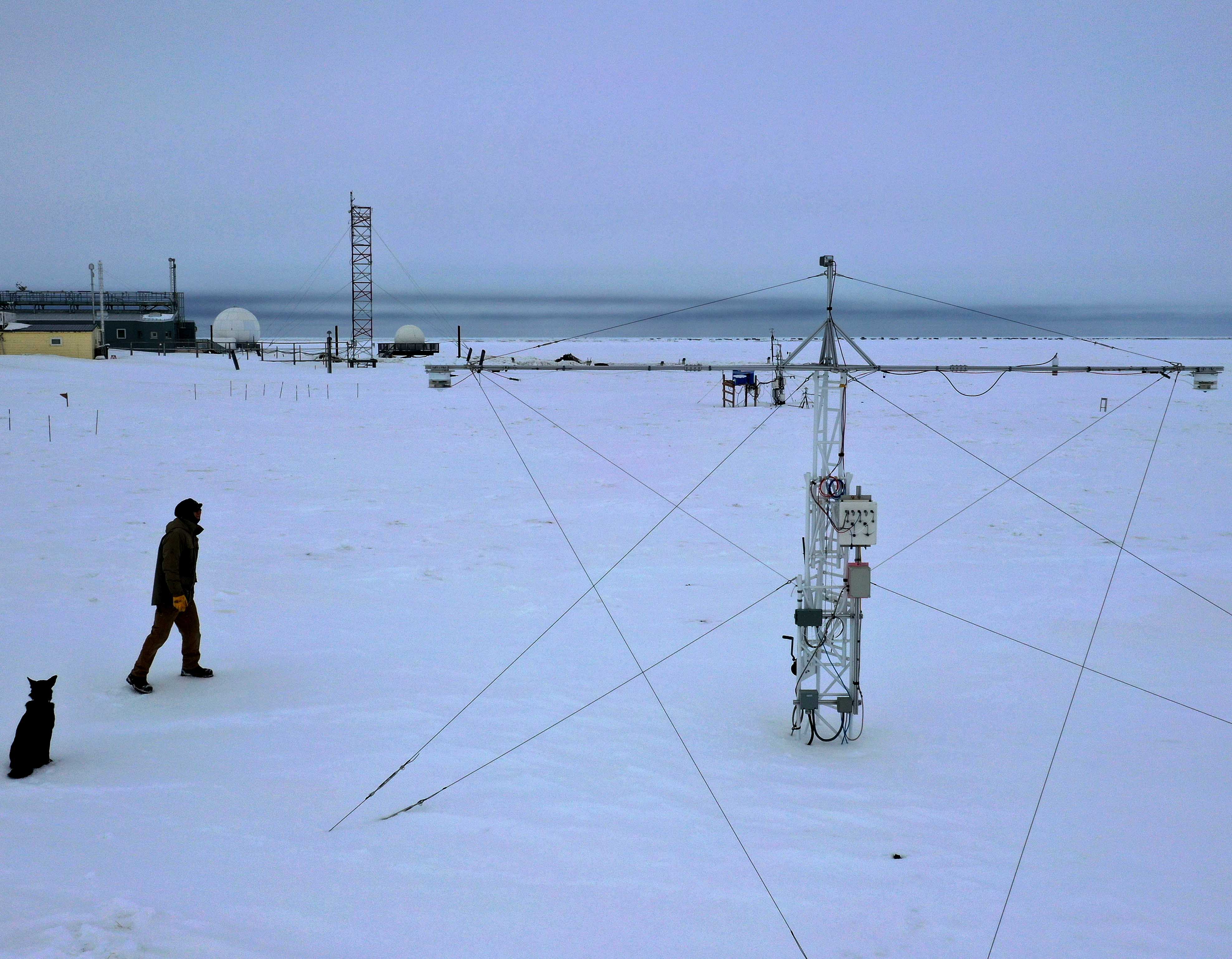 Ross Burgener, NOAA technician, inspects the albedo rack housing instruments used to calculate snowmelt dates. These dates become part of a long-term record. At Barrow, spring melt dates are typically beginning earlier and snow is arriving later in the fall, which is extending snow-free periods.