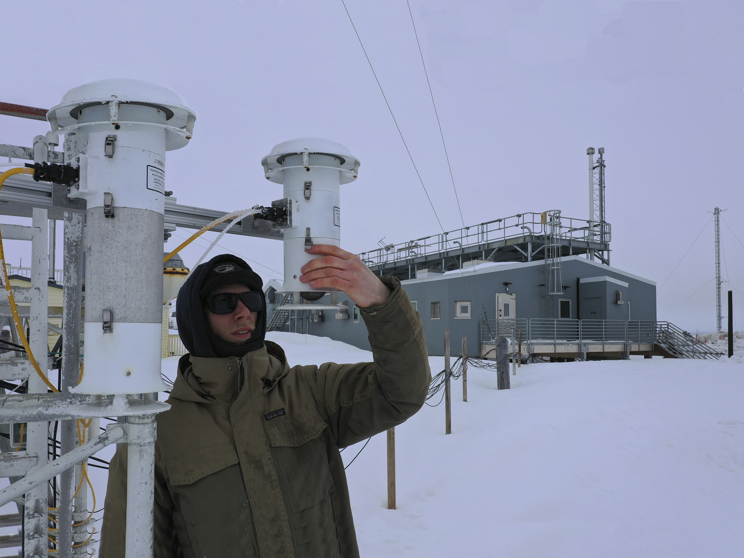 Verifying Air Purity — Ross Burgener, NOAA technician, checks a temperature sensor that works with meteorological instruments that track wind speed and direction. The instruments help gauge air purity.  Impurities can radically skew greenhouse gas measurements.