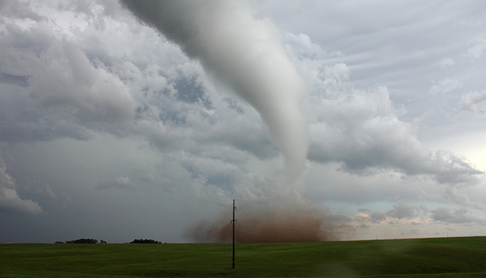 Touching down just next to the researchers, this June 12 tornado near Cheyenne, Wyoming, was the first of several tornadoes sampled during one dramatic, busy day. Soon after, a second tornado from the same storm formed nearby. About an hour later, another storm produced at least two more tornadoes. Hail as large as baseballs pounded the research vehicles during these storms. A metal wire cage custom-built by an NSSL scientist shielded the roof and hood of the truck, protecting the front windshield and the