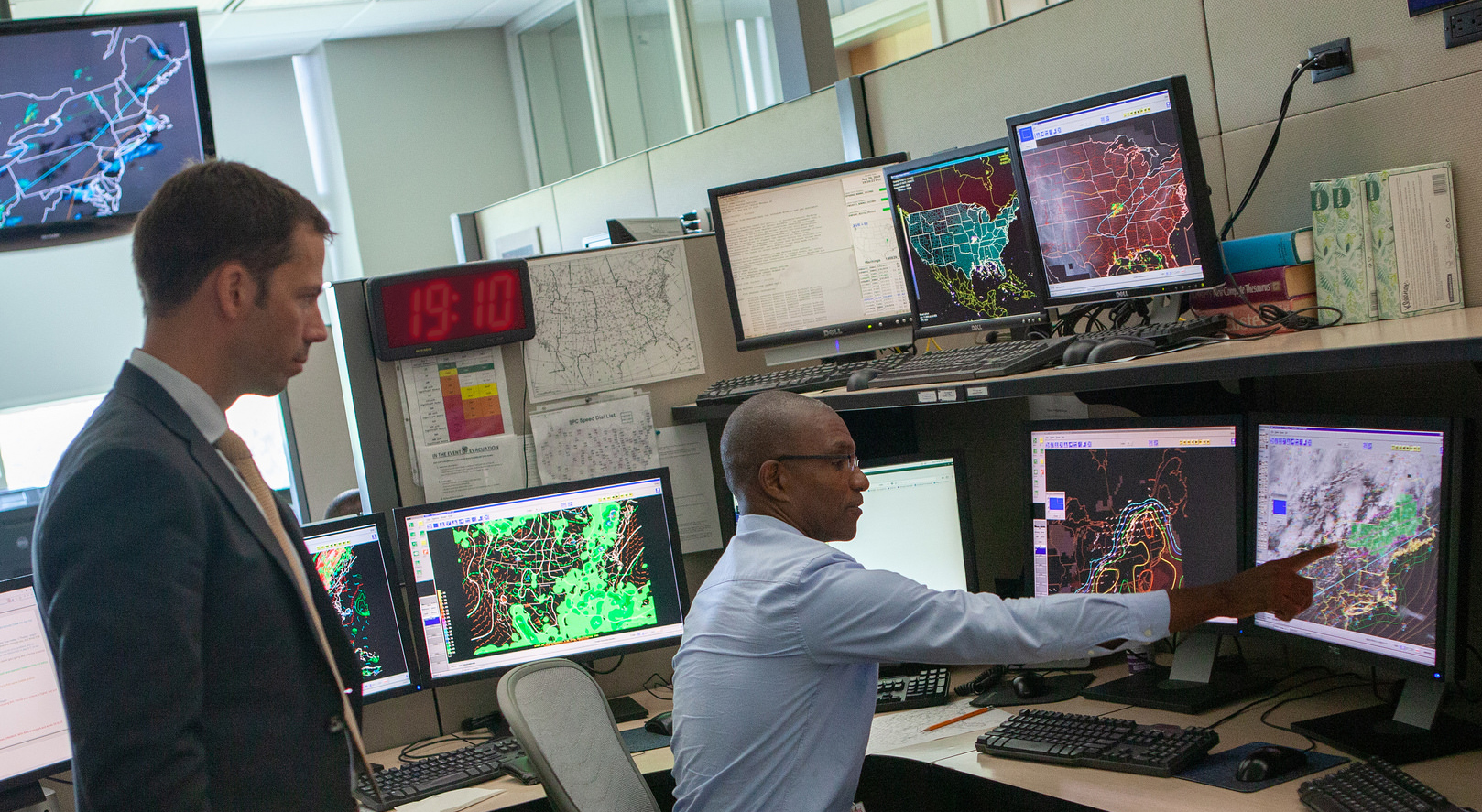 NOAA forecaster Greg Dial shows Dr. Neil Jacobs satellite imagery at NOAA's Storm Prediction Center in Norman, Oklahoma. A severe thunderstorm watch was proposed for the area shaded in green.