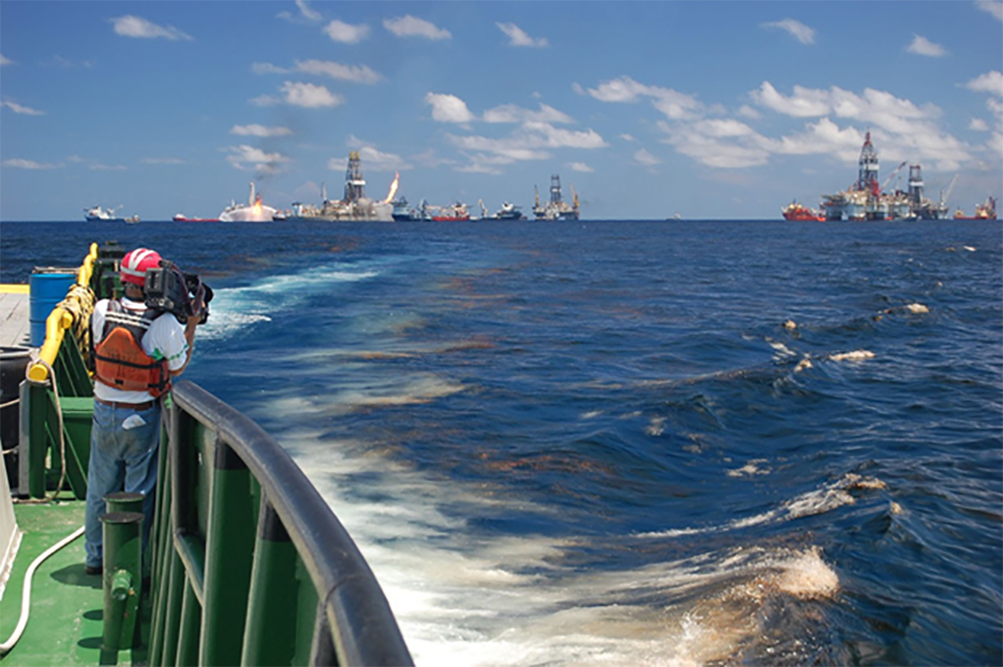 National Geographic videographer Bob Perrin films an oil slick at the Deepwater Horizon site.