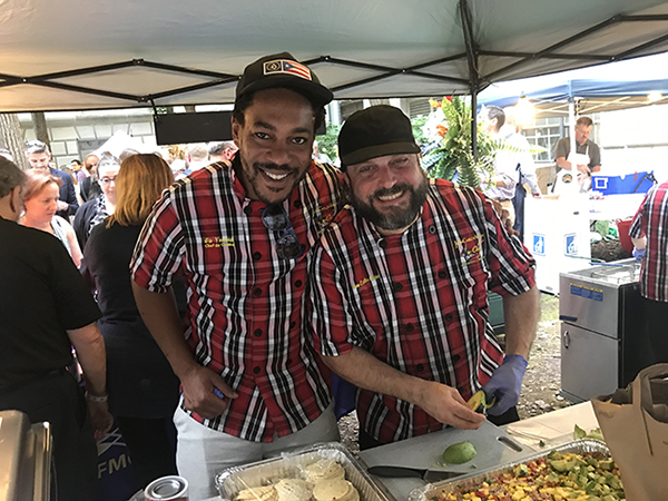 Chef Gio and Chef Juan, left to right, from the Caribbean Fishery Management Council serve corn sorullitos with lobster “fricassée” 
