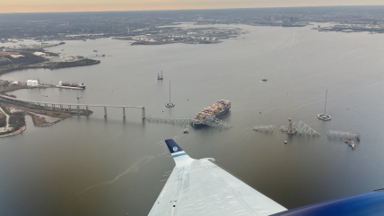 March 28, 2024: View from NOAA King Air N68RF during a navigation survey following the collapse of the Francis Scott Key Bridge. The bridge and the MV Dali, which collided into it, are visible.