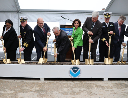Photo of individuals digging with gold shovels as part of the groundbreaking ceremony for NOAA Marine Operations Center-Atlantic on May 6, 2024.