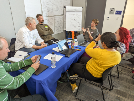Photo showing Las Vegas community members work together to brainstorm heat resilience strategies during a tabletop exercise in December 2022. (Image credit: Hunter Jones/ NOAA).