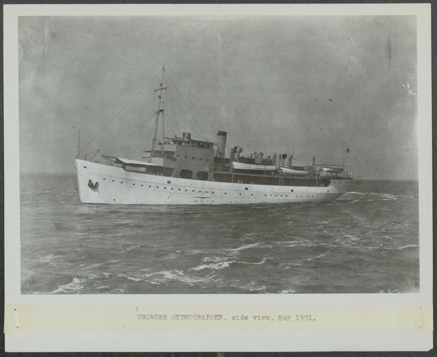 A black and white photo of the Hydrographer at sea with a label below that reads, "USC&GS HYDROGRAPHER, side view, May 1931."