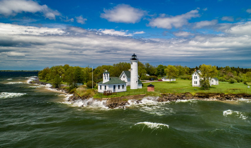 An aerial view of historic Tibbetts Point Lighthouse in the Town of Cape Vincent in Jefferson County, New York. The lighthouse marks the point where Lake Ontario meets the St. Lawrence River and overlooks the eastern boundary of Lake Ontario National Marine Sanctuary.