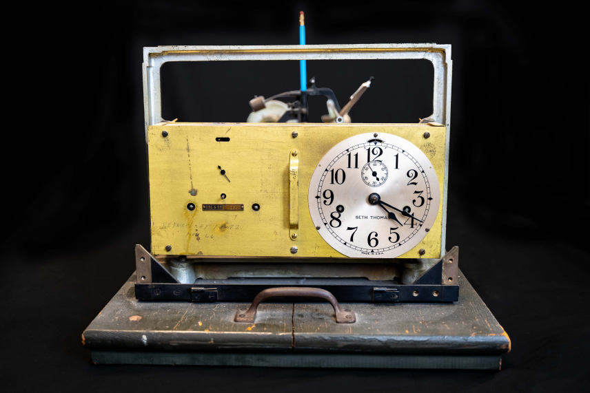 The clock on a historic Standard Tide Gauge. The brass plate is labeled, “USC & GS T-250” and a scrawled note in the lower left reads, “Repaired by Fowtz. Nov 66.”