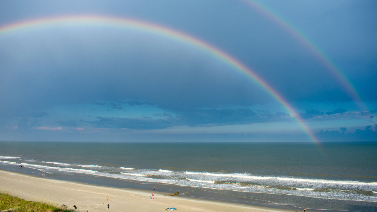 A double rainbow shines through dark clouds above North Myrtle Beach, South Carolina.