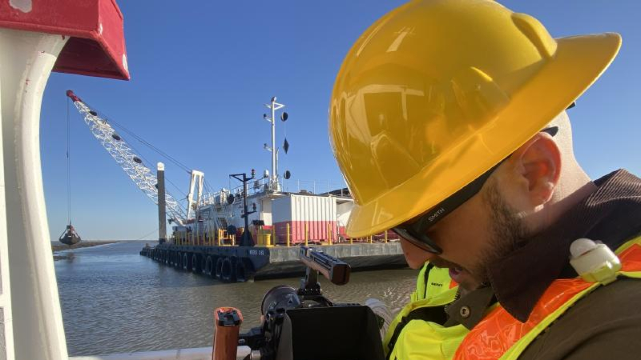 Photographer taking pictures of construction near basin
