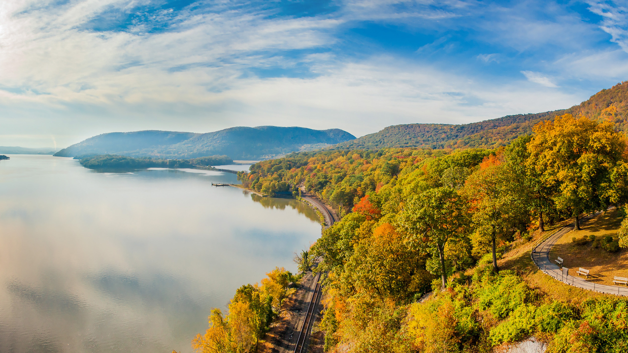 Photo showing water and fall covered foliage in New York State.