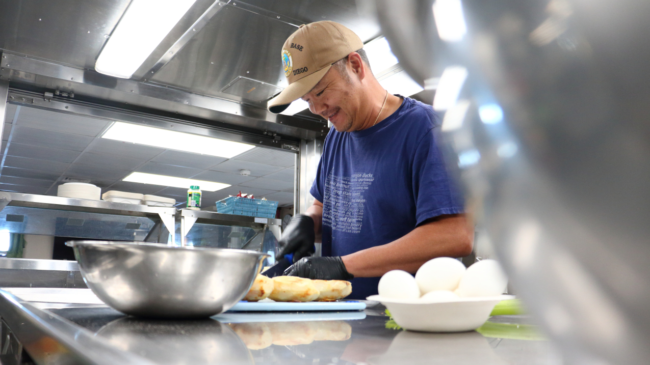 Photo of Arnold Dones, the chief steward, or chef, aboard NOAA Ship Reuben Lasker, prepares a delicious meal for the ship’s crew and scientists.