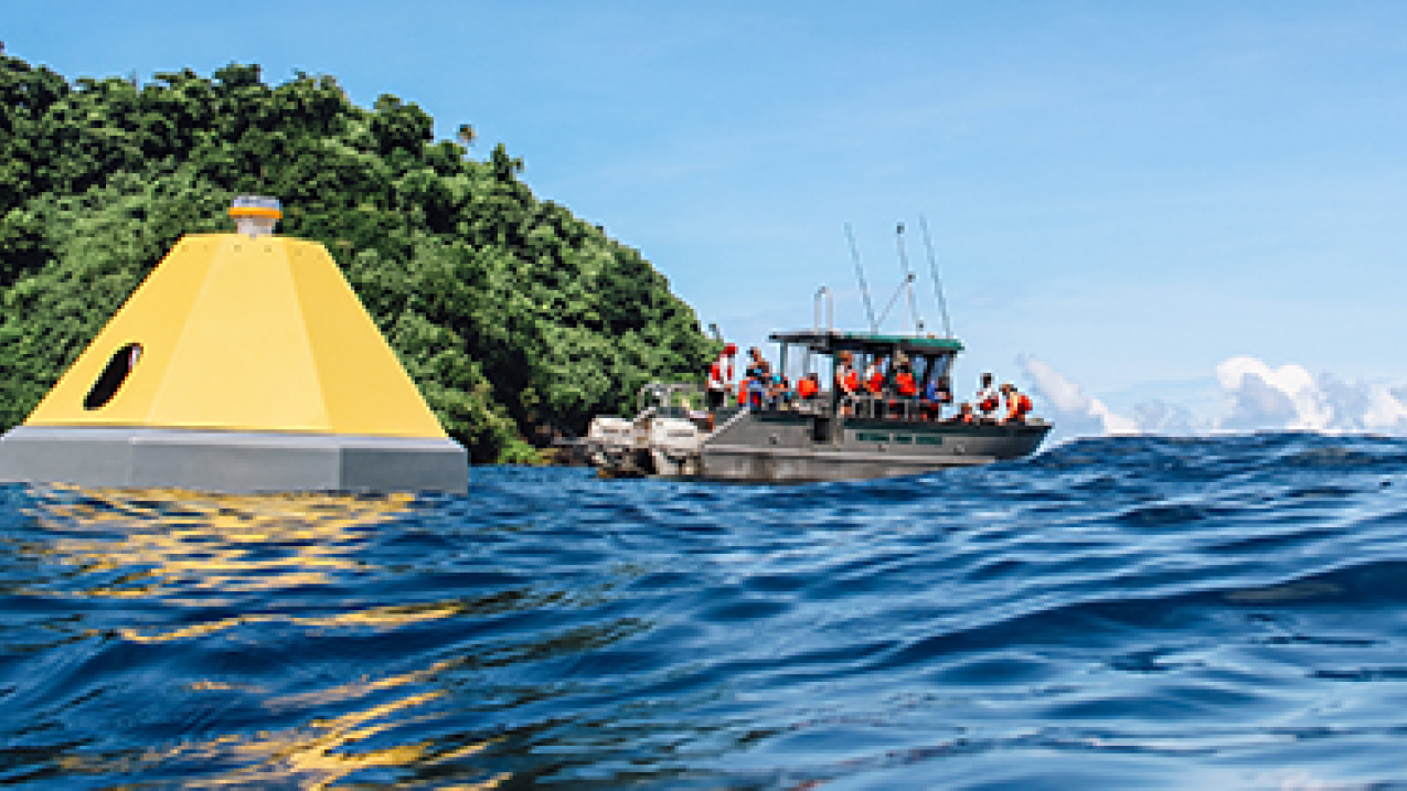 Pontoon fishing boat floating next to a buoy
