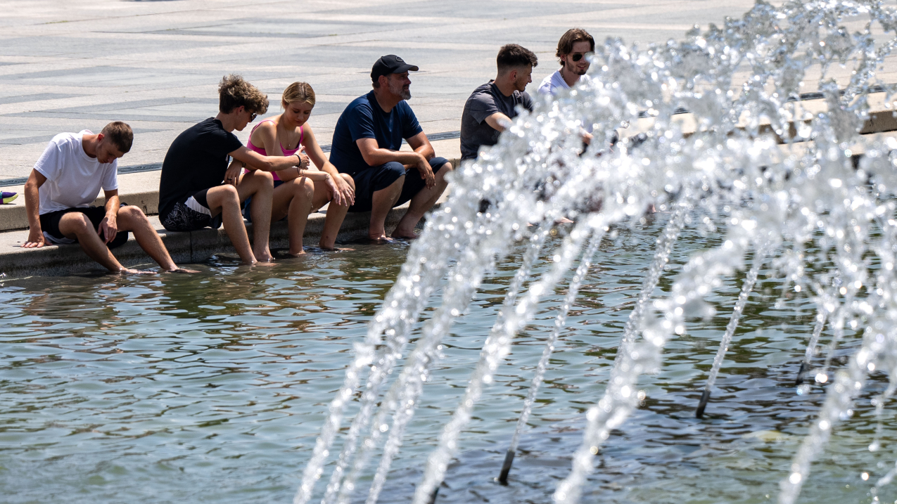 AUGUST 2, 2024: People cool off on the National Mall in Washington, D.C. The D.C. area was under an excessive heat warning that day. Summer 2024 was the fourth-hottest summer on record for the U.S.