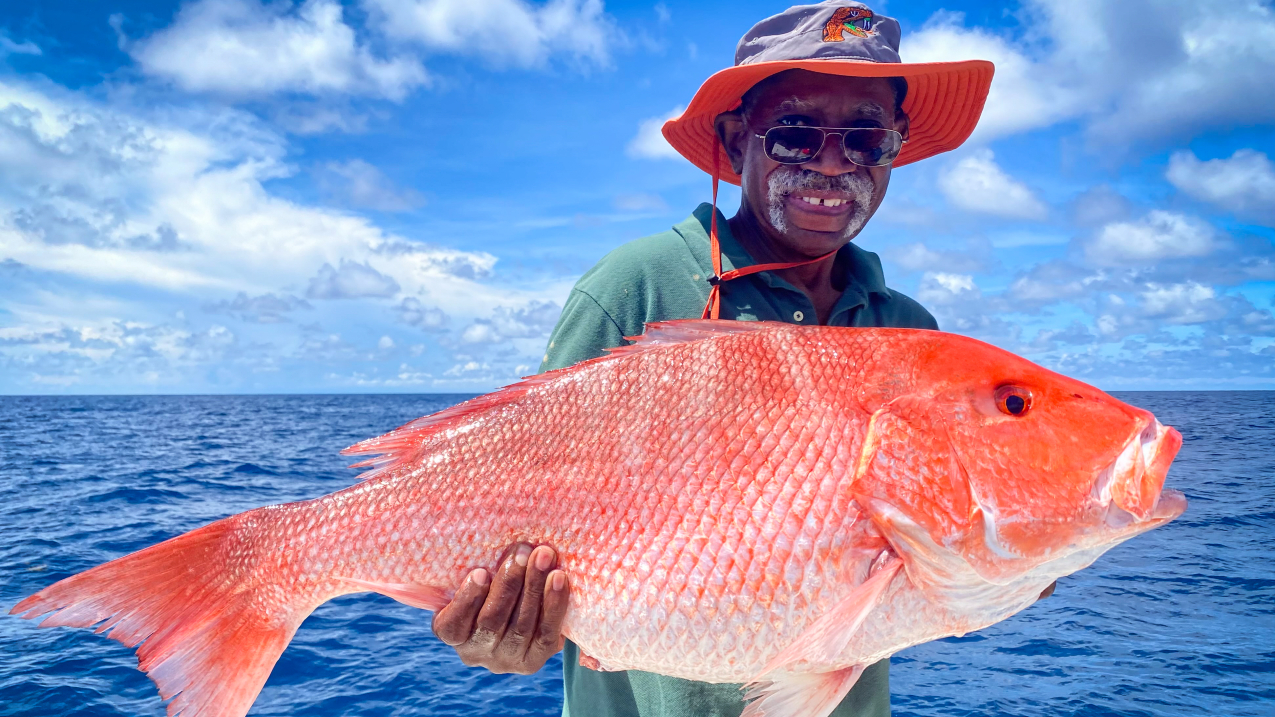 Photo showining Frank Williams, a recreational angler, holds up a red snapper caught in the Gulf of Mexico on board a charter boat. Credit: Captain Grayson Shepard.