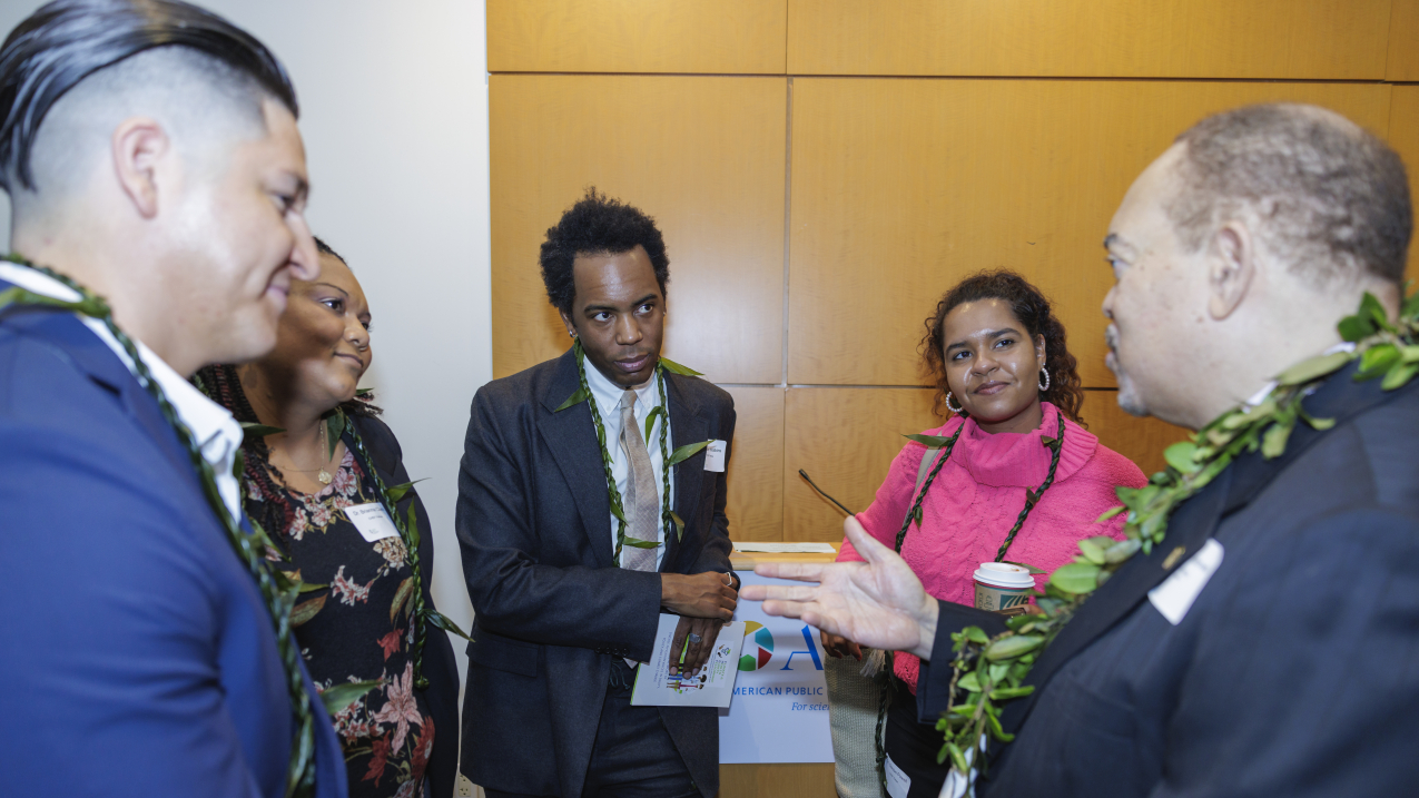 Photo showing Medical doctors, from left to right, Marcus Moreno, Brianna Clark, Julian Watkins and Denise Powell gather with Climate & Health Equity Fellowship founder Mark Mitchell, right, after their graduation on December 9, 2023, as Climate & Health Equity Fellows. The Medical Society Consortium on Climate and Health announced that a new policy fellowship has started this year. Photo credit: Lathan Goumas/ Virginia Sea Grant
