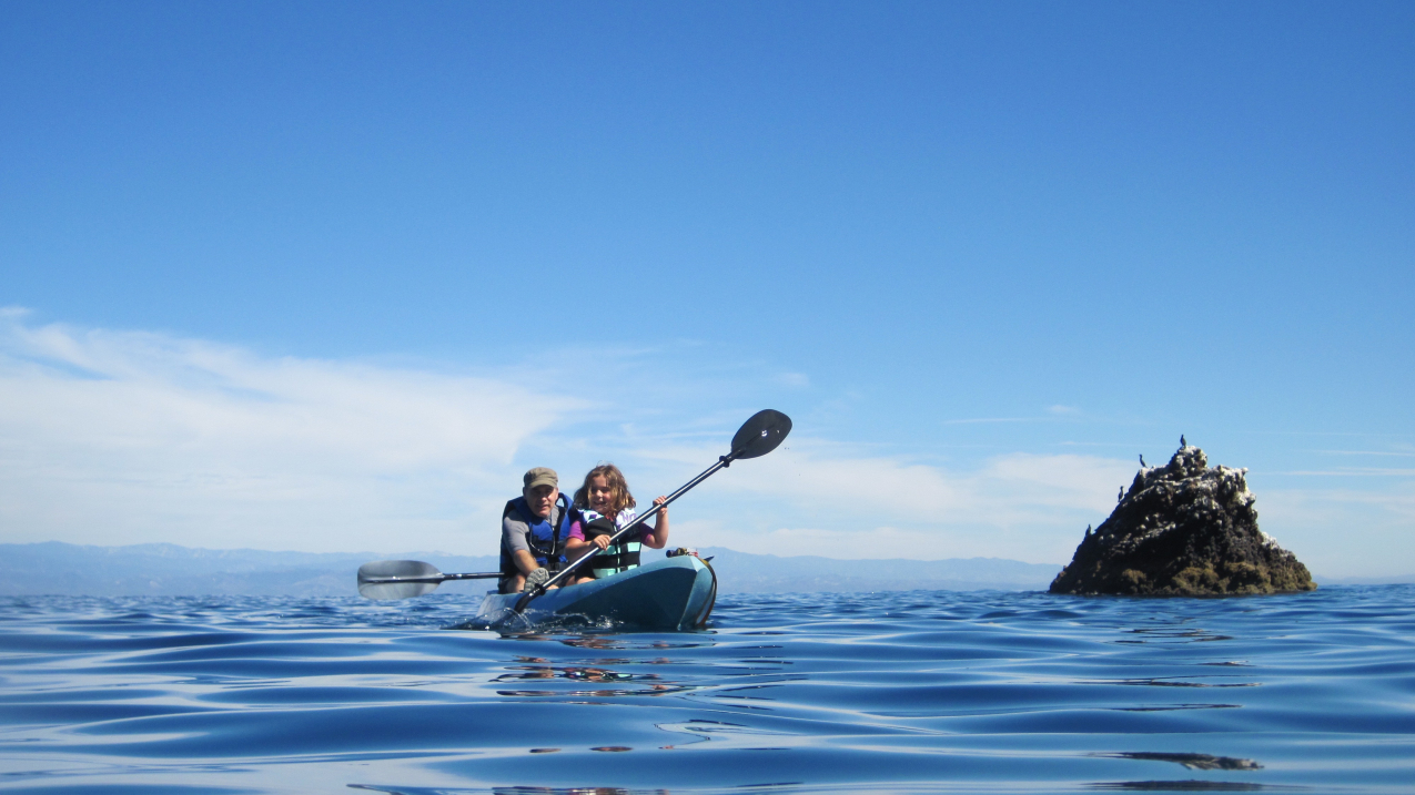 A father and daughter enjoy a kayak trip in NOAA's Channel Islands National Marine Sanctuary. Be sure to check the weather forecast before venturing out on the water, wherever you might be.