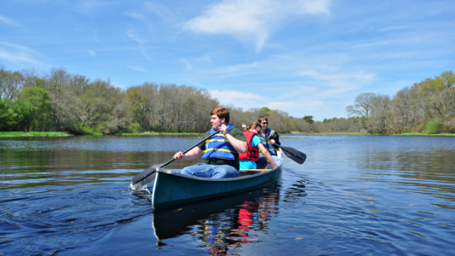 Photo of people canoeing on water.