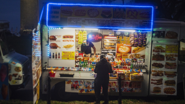 A colorful food truck parked near the grounds of the Washington Monument in Washington, D.C.