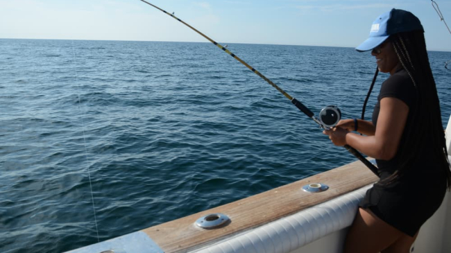 Person fishing on a charter boat.
