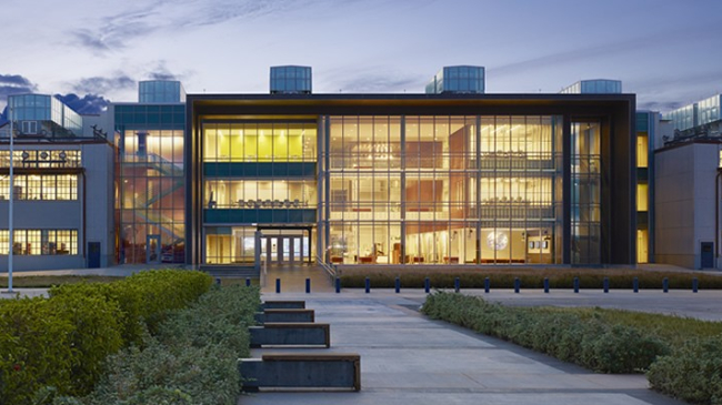 NOAA Inouye Regional Center. Front view of illuminated building.