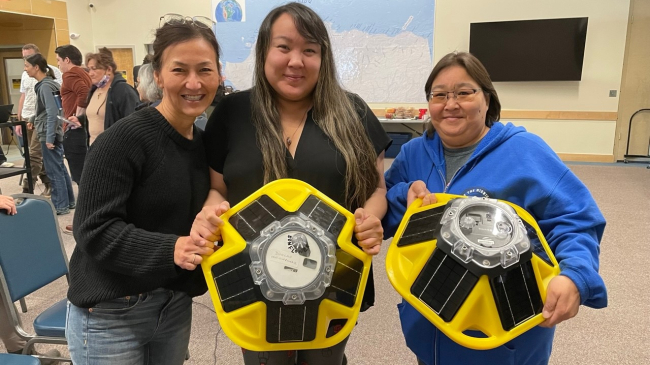 Alaska Eskimo Whaling Commission staff hold Sofar buoys at co-production workshop.