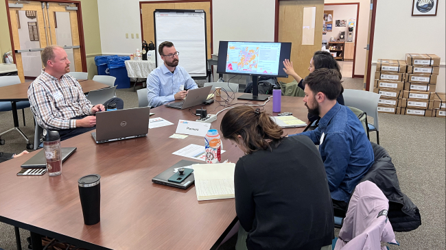 Climate practitioners sit at a table.