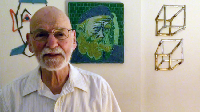 Jerome "Nick" Heffter stands before an art display.