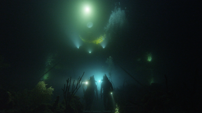 Ocean explorer Fabien Cousteau leads Mission 31 team on a night exploration dive out of Aquarius underwater lab off the Florida Keys, as photographed from outside of Aquarius, which was operated until 2013 by NOAA and partners and is now run by Florida International University. The Aquarius lab inspired ocean explorer Fabien Cousteau, who spent 31 days on the Mission 31 expedition, to plan and develop the new PROTEUS™ underwater habitat.