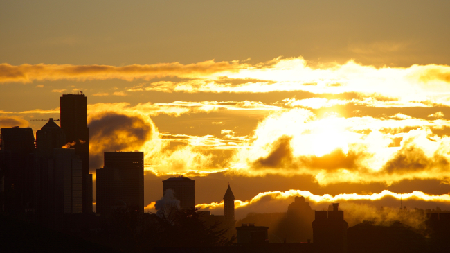 he sun rises over Seattle, Washington.