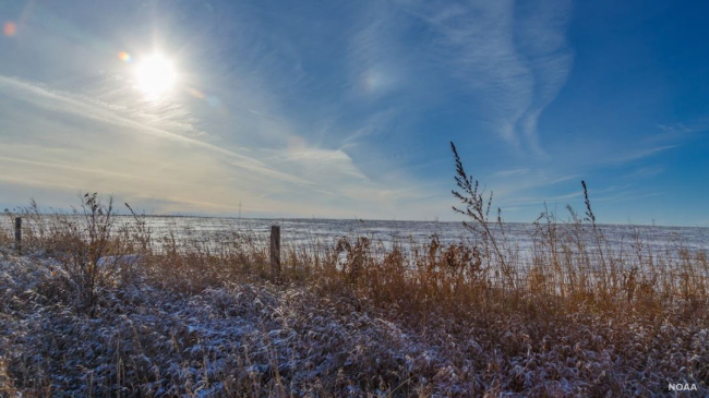 Photo showing light snow on a field in Iowa.