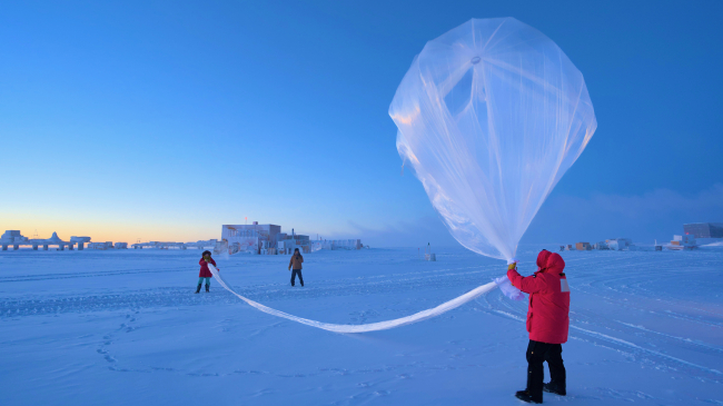 NOAA scientists launch a weather balloon carrying an ozonesonde at the South Pole on October 1, 2023.