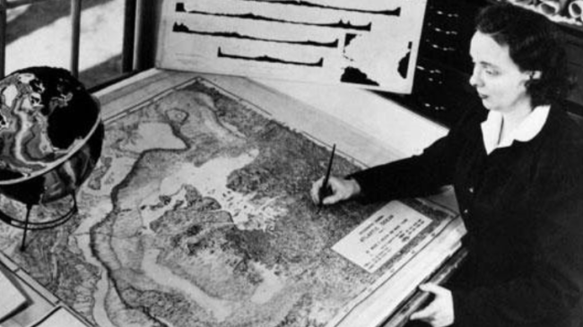 Black and white photo of Marie Tharpe at her drafting table in 1961.