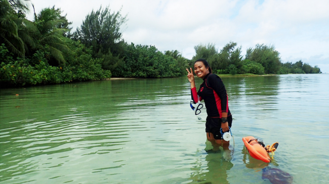 Dianne posing in knee-high water in snorkeling gear.