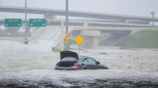 HOUSTON, TEXAS - JULY 8, 2024: A vehicle is left abandoned in floodwater on a highway after Hurricane Beryl swept through the area. Credit: Getty Images.