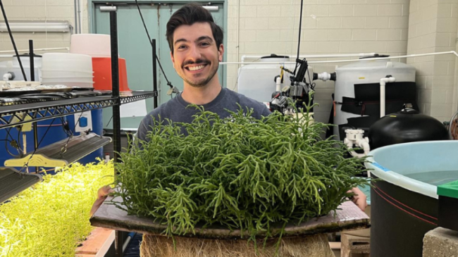 NOAA researcher Mike Acquafredda holds a tray of sea beans.