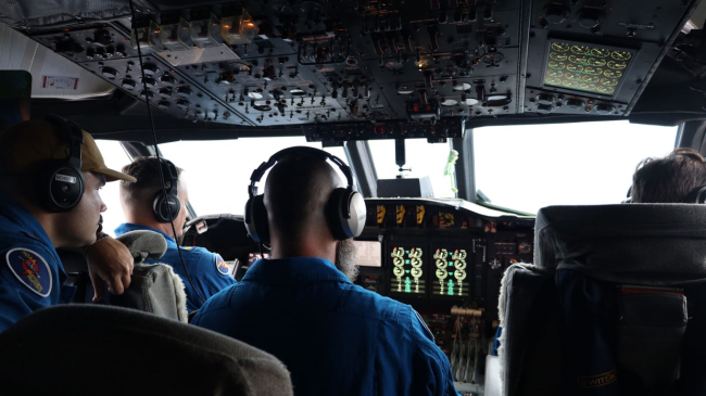 Aviators inside the Hurricane Hunter P-3 Orion prepare to fly into a developing storm to gather critical data to improve hurricane forecasts.