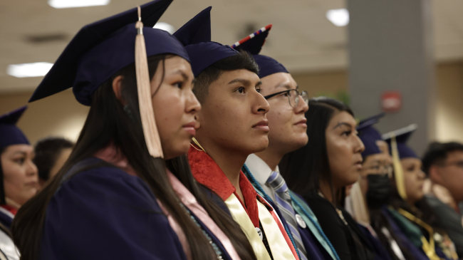 Pnoto showing graduates listen to speakers at the University of Arizona’s 2022 convocation ceremony for Native American Student Affairs. Credit: Chris Richards/University of Arizona.