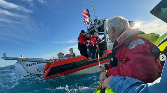 Photo showing Coast Guard rescuimg 6 people who activated an Emergency Position-Indicating Radio Beacon (EPIRB) after their 48-ft fishing vessel began sinking off the coast of Oak Island, North Carolina, on December 8, 2024 (Credit: USCG). 