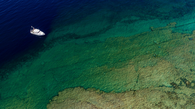 Researchers on NOAA's Research Vessel Storm pause above the Middle Island sinkhole in northern Lake Huron, off the coast of Alpena, Michigan. July 17, 2019.