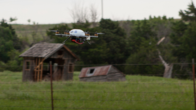An unmanned aircraft system flies just above the ground, taking measurements of the atmosphere before severe storms form. 