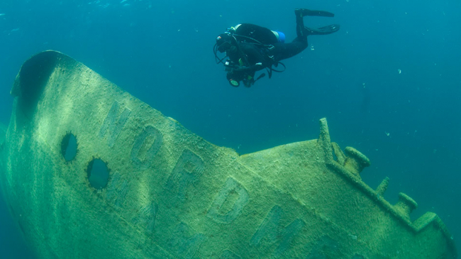 Just below the surface of Lake Huron, a diver photographs the German freighter Nordmeer, which ran aground in 1966 and eventually sank in 40 feet of water.