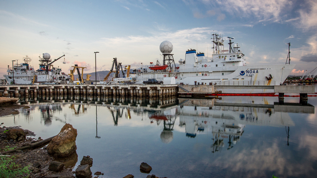 NOAA Ship Okeanos Explorer (right) in port on Ford Island, Pearl Harbor, Hawaii, before the first remotely operated vehicle expedition of CAPSTONE in July 2015. 