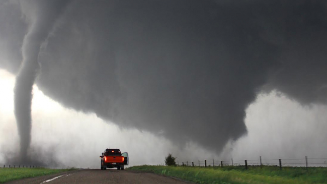 A satellite tornado circulates around a newly formed tornado.