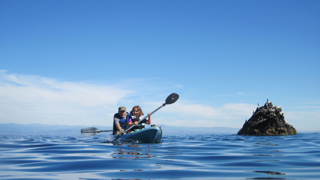 A father and daughter enjoy a kayak trip in NOAA's Channel Islands National Marine Sanctuary. Be sure to check the weather forecast before venturing out on the water, wherever you might be.