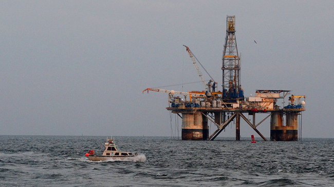 October 13, 2020: Launch Boat 2904 from the NOAA Ship Thomas Jefferson conducts a hydrographic survey of the Calcasieu Ship Channel in Louisiana to search for navigational hazards after Hurricane Delta came through the area. An offshore oil platform in the background.
