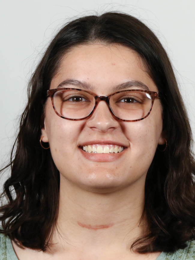 A headshot of Asha Spencer.