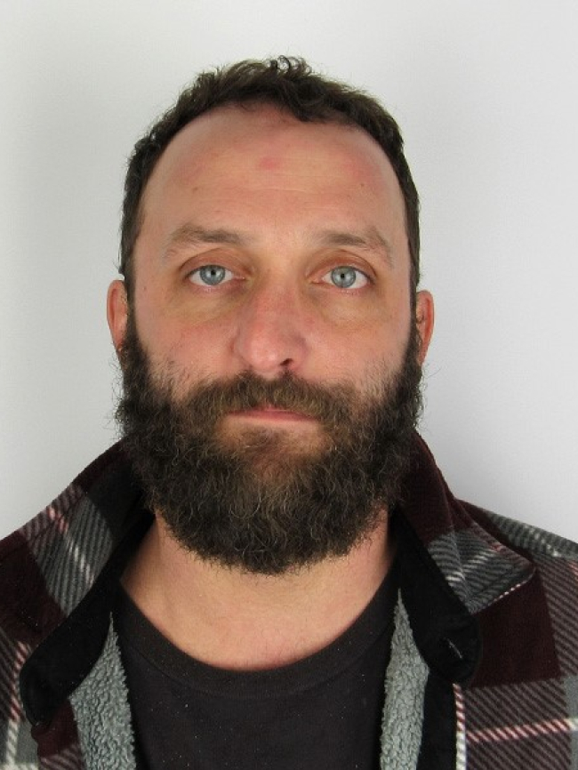 A headshot of Ryan Ursíny.