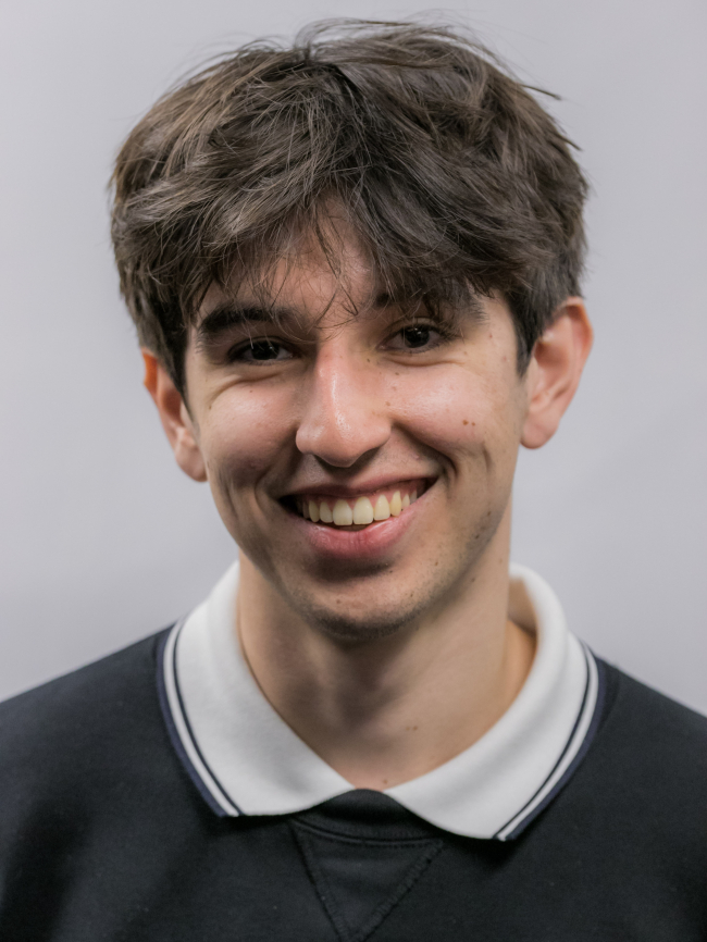 A headshot of Conrad Avila.