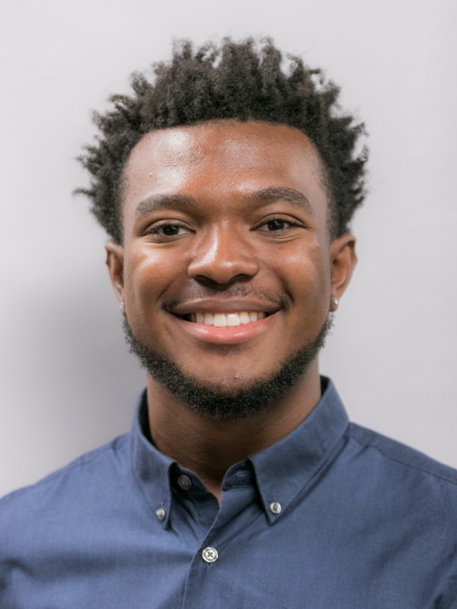 A headshot of Malik Hall.